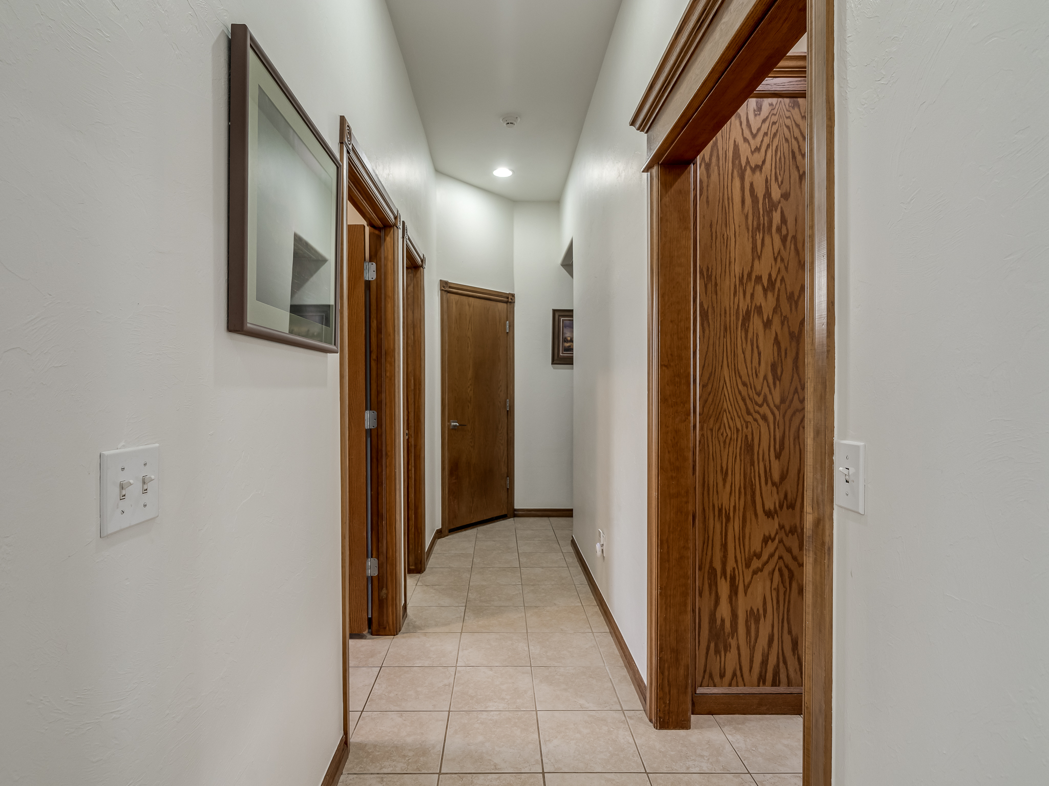Hallway to Kitchen, Laundry Room, Guest half bath, Garage and Primary Bedroom
